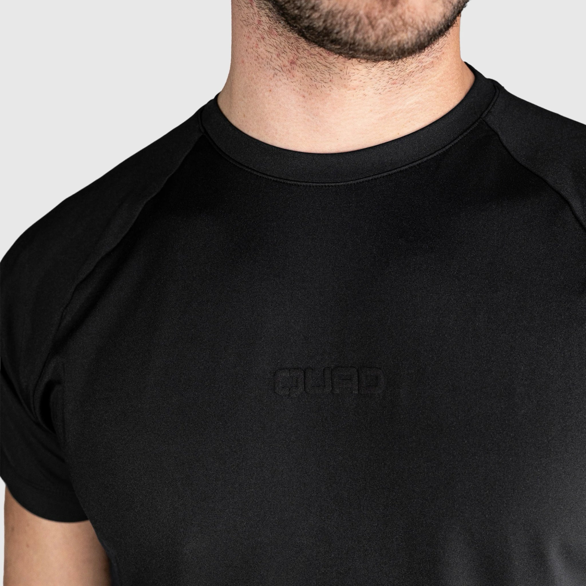 QUAD Ace Padel T shirt with a brand logo on a plain background