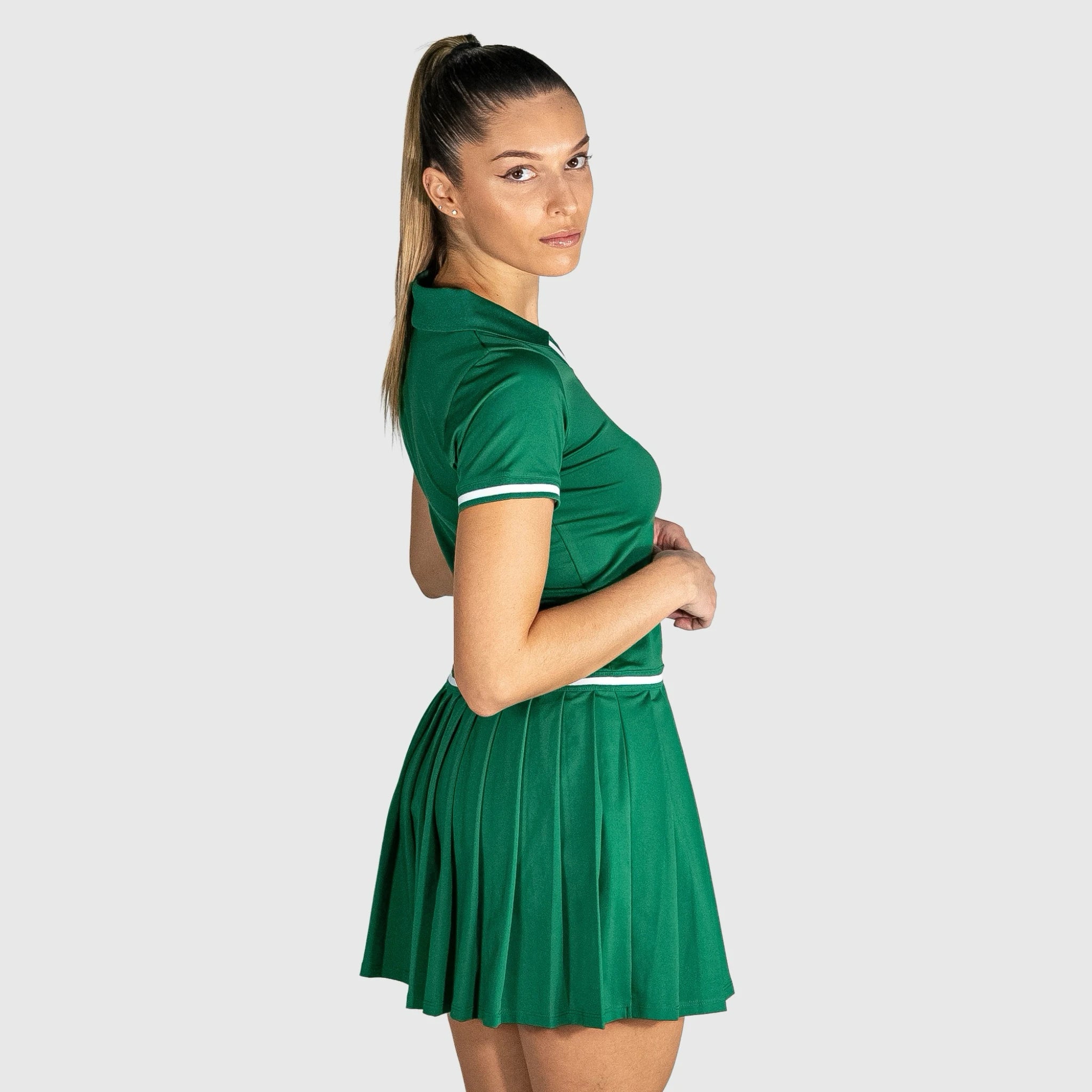 Woman wearing QUAD Court Padel Dress with white trim on a light gray background