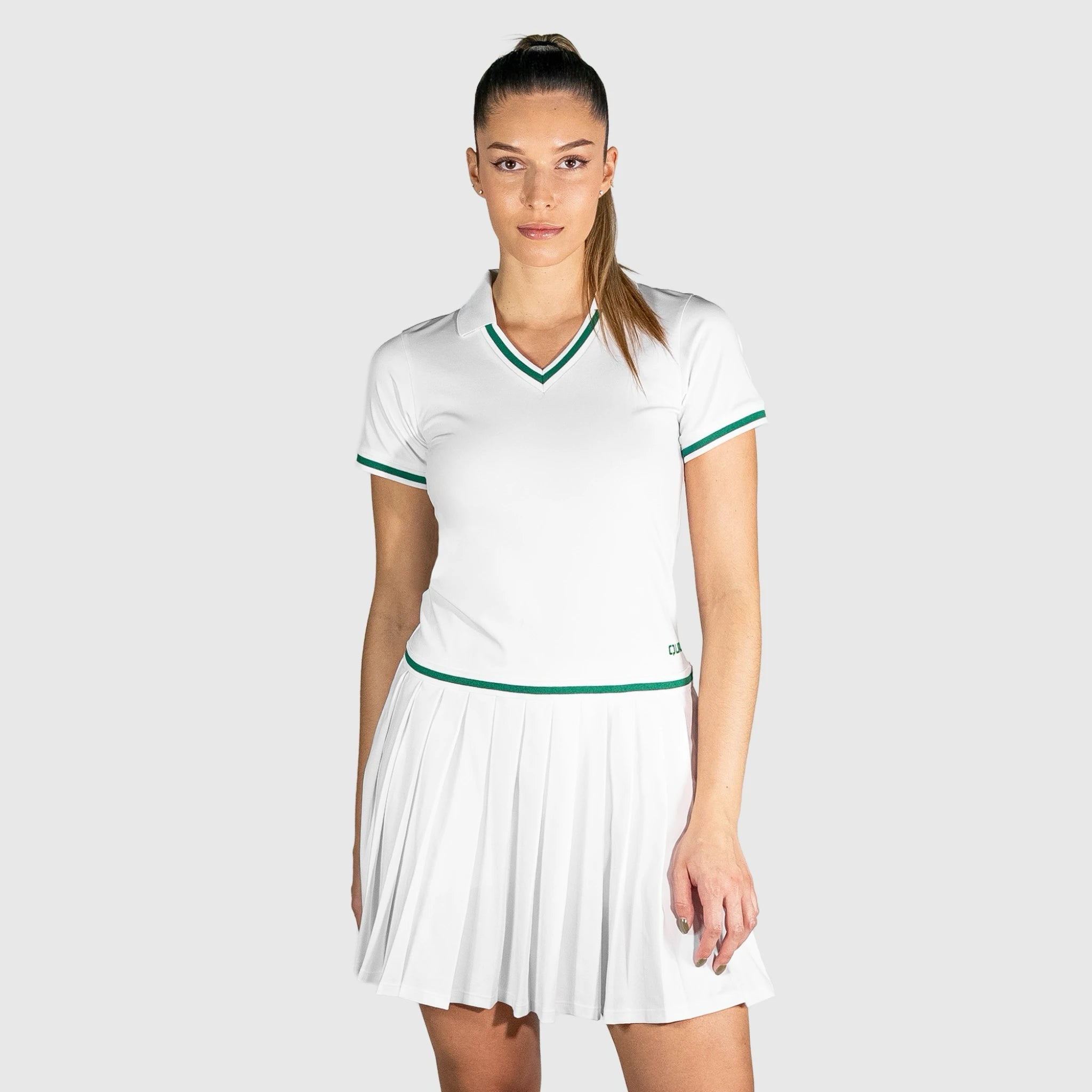 Woman wearing a QUAD Court Padel Dress with green accents on a light gray background