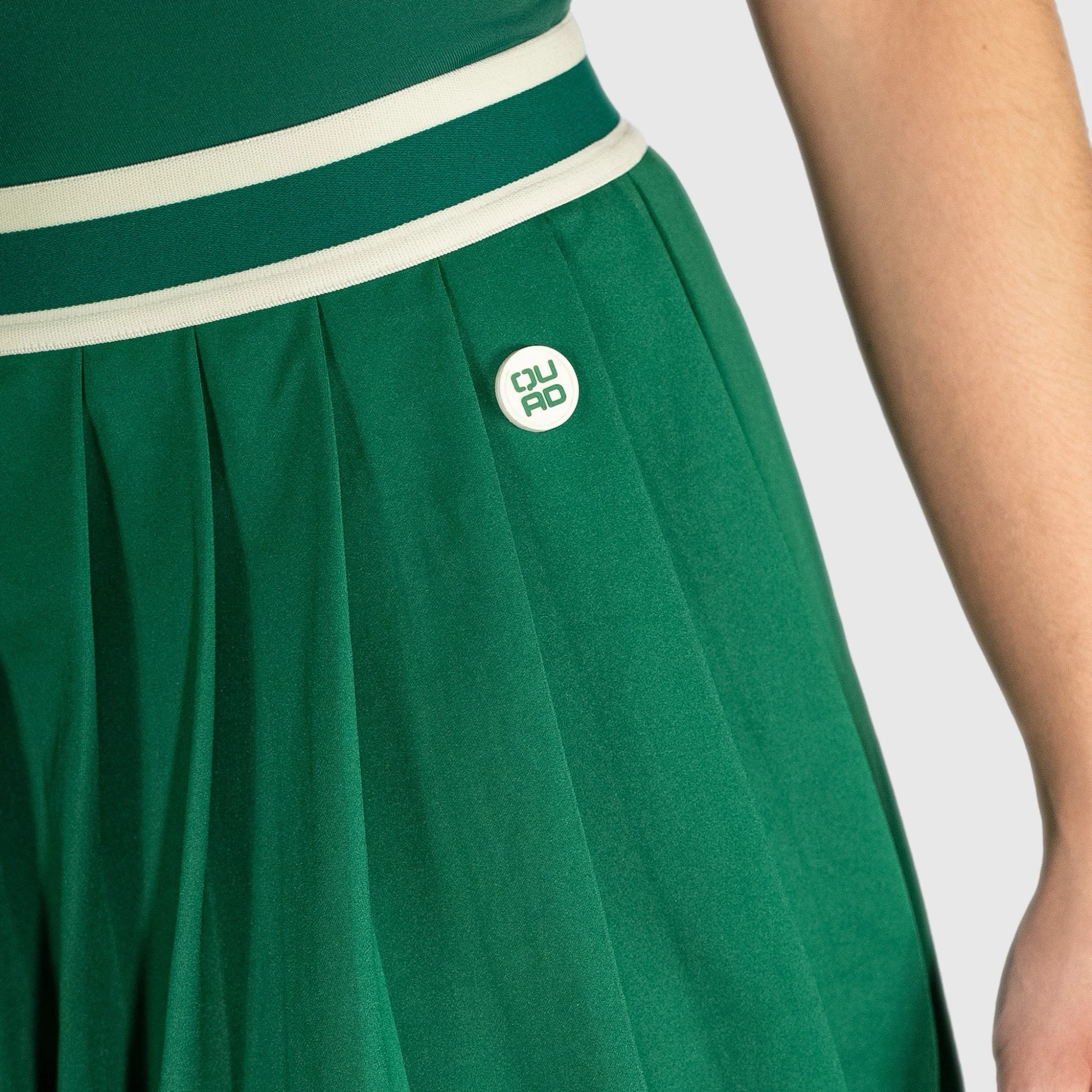 QUAD Flare padel skirt with a white band and visible brand logo on a plain background