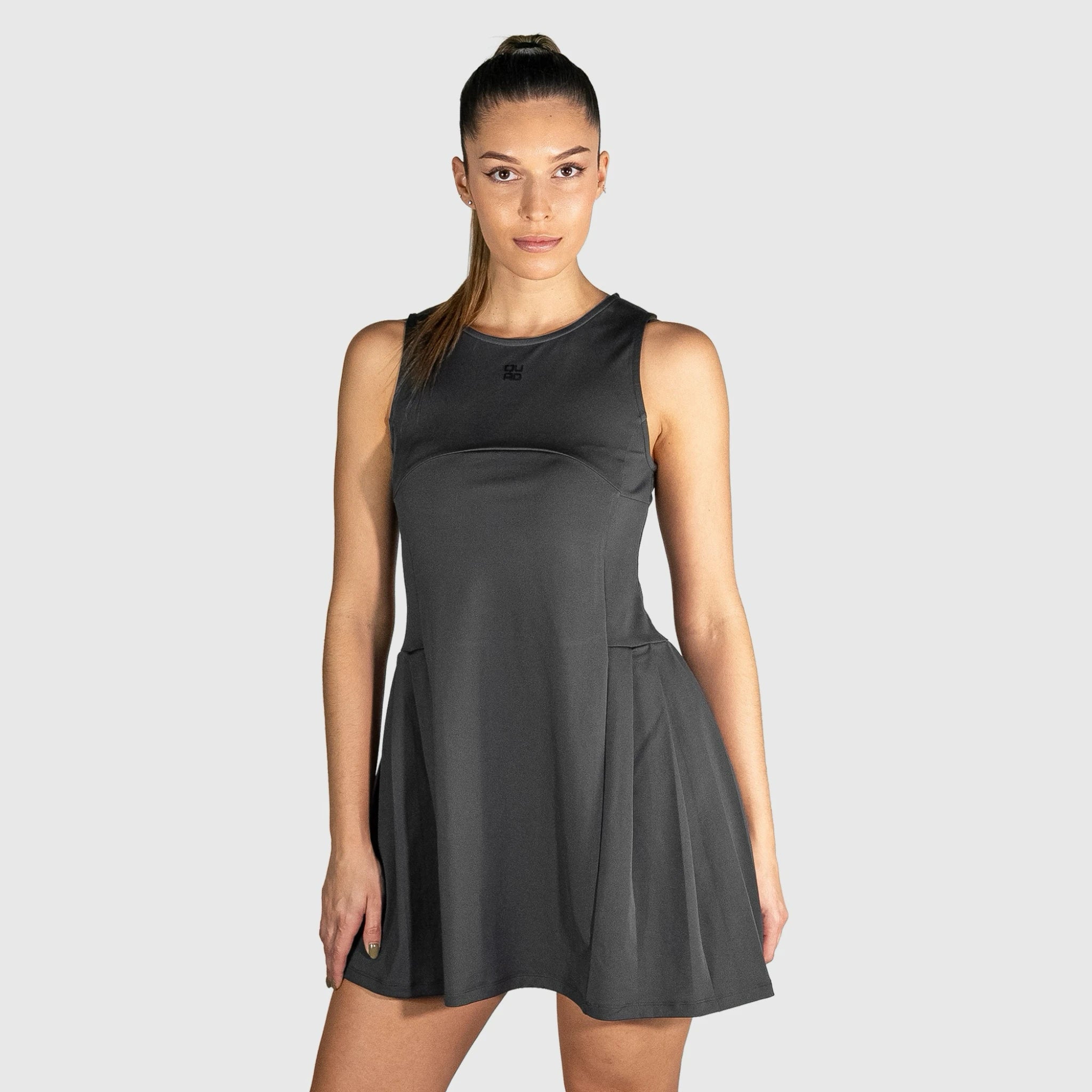 Woman wearing a black QUAD Frame Padel Dress on a white background