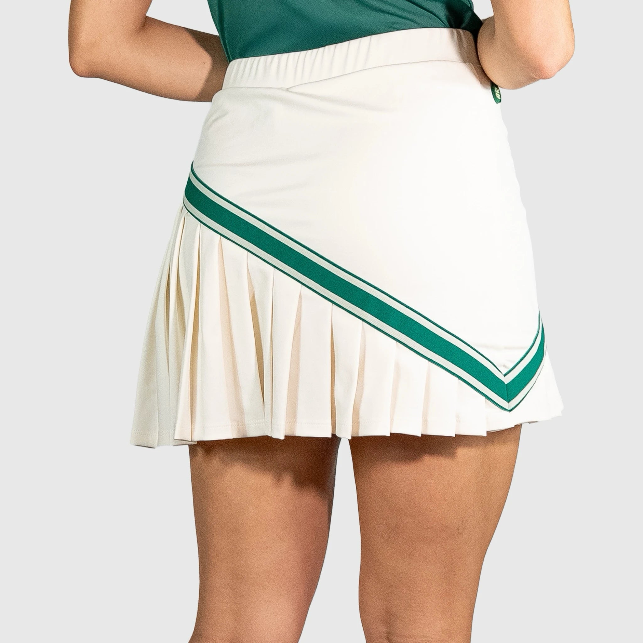 QUAD Halo Padel Skirt with green stripes worn by a person on a white background