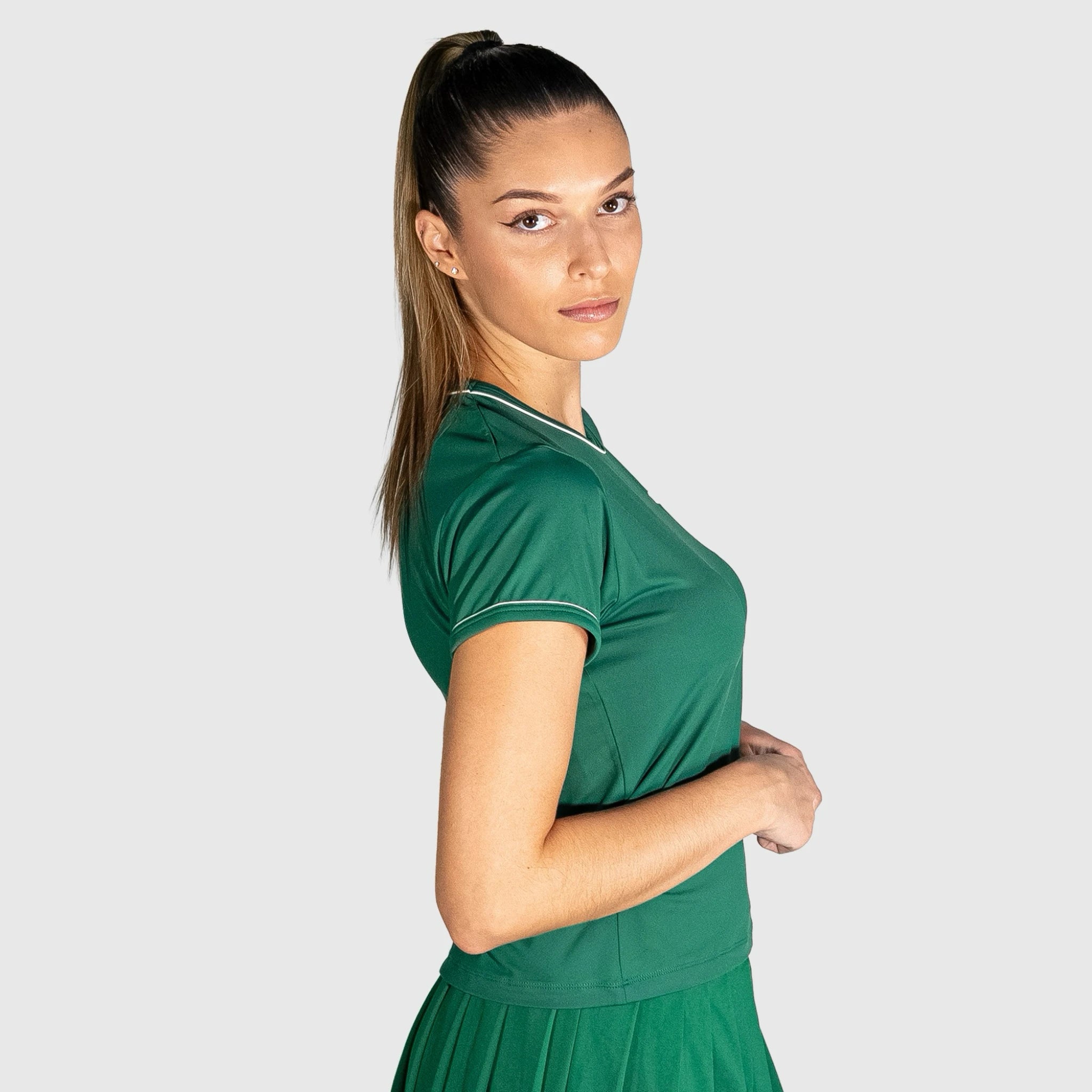 Woman wearing a New Regular Padel shirt against a plain background