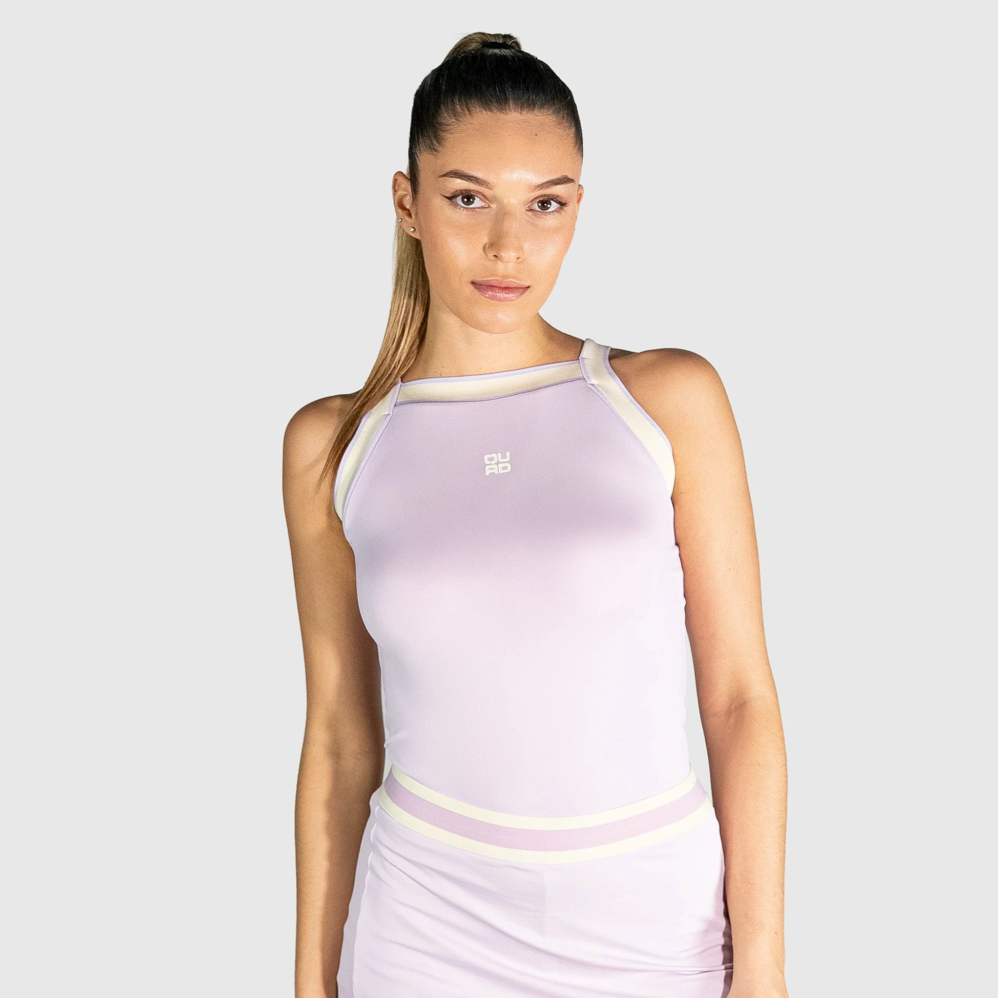 QUAD Aim Padel Top a light purple sleeveless top with a logo on a white background