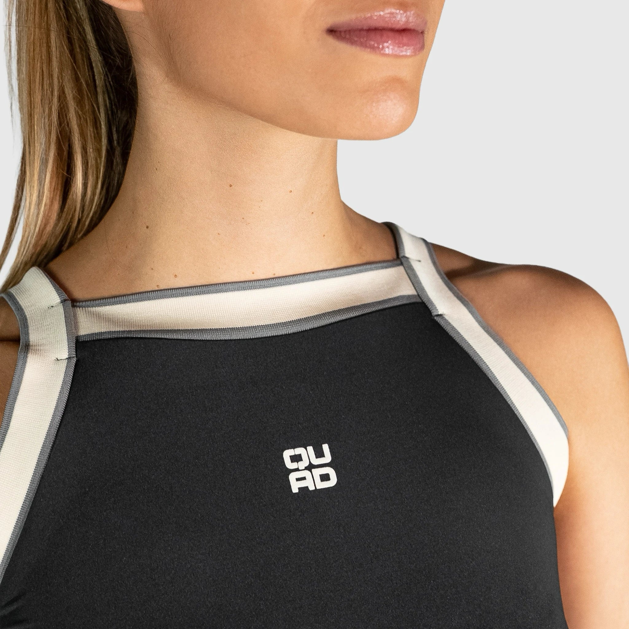 QUAD Aim Padel Top with beige accents and a visible brand logo on a plain background