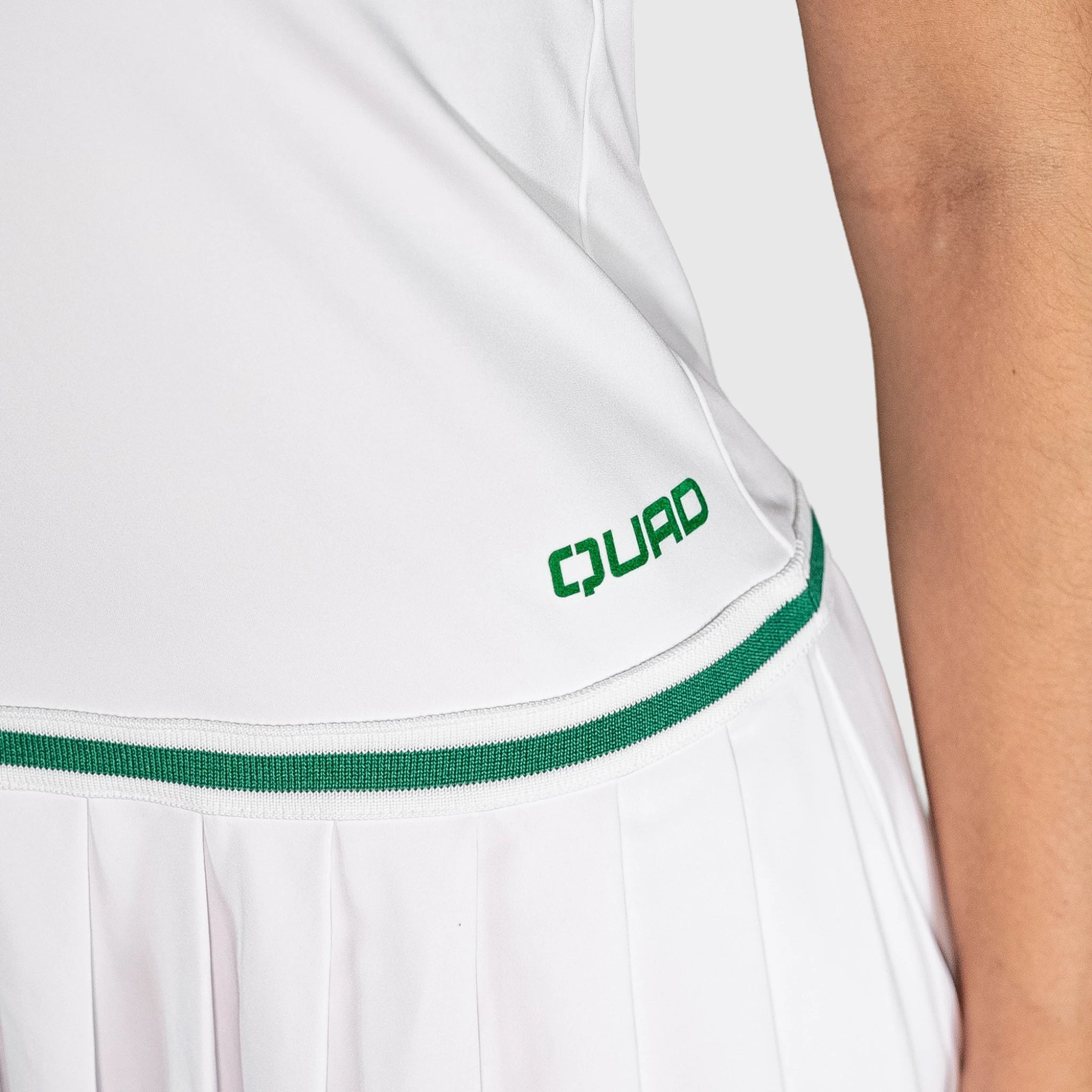 QUAD Court Padel Dress with green trim and 'QUAD' logo on a person wearing it.