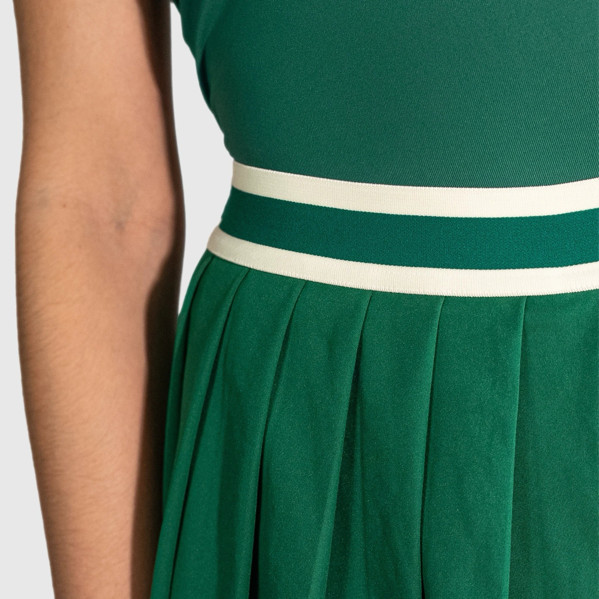 QUAD Flare padel skirt with a white waistband on a plain background