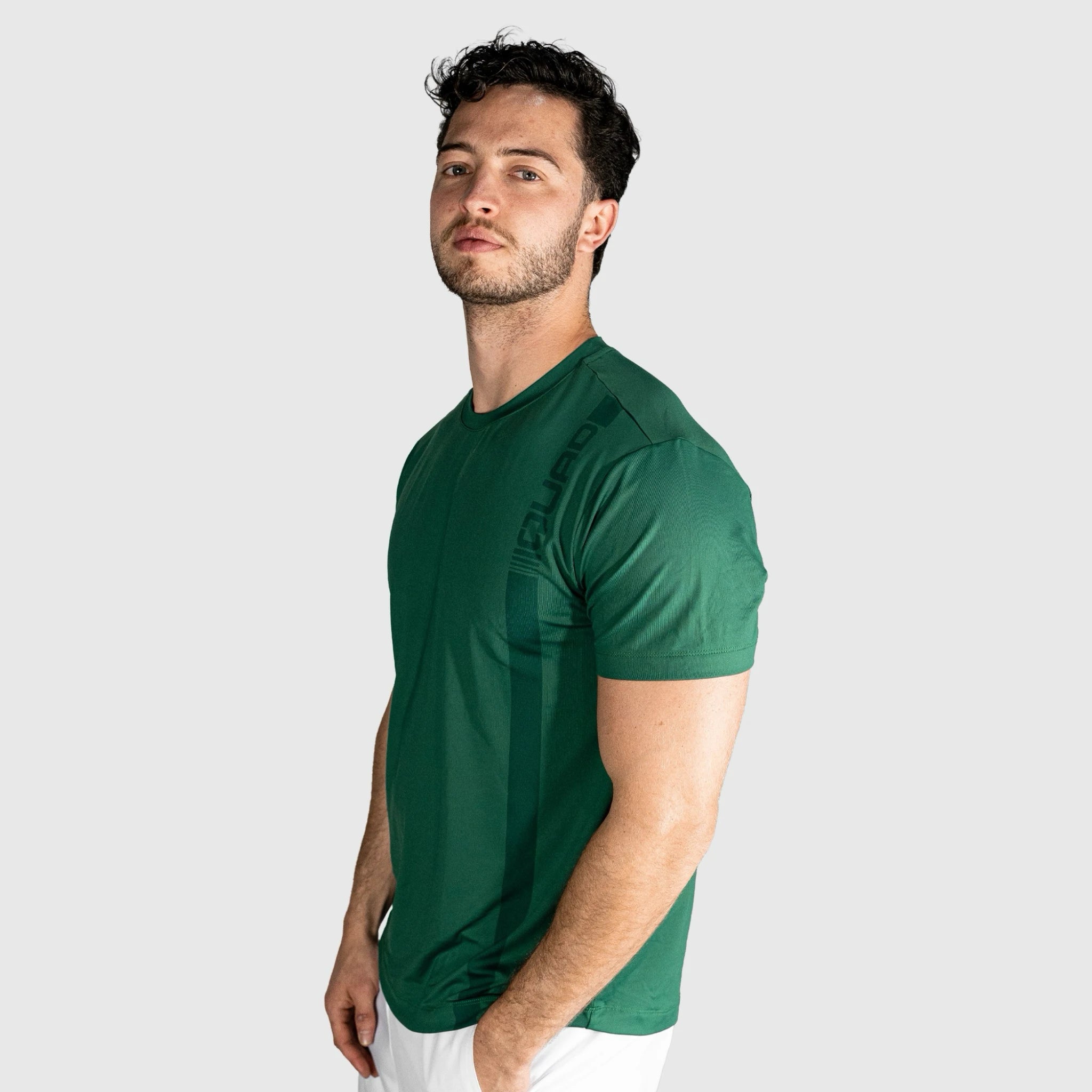 Man wearing a Impact Padel T-shirt-green  on a light grey background