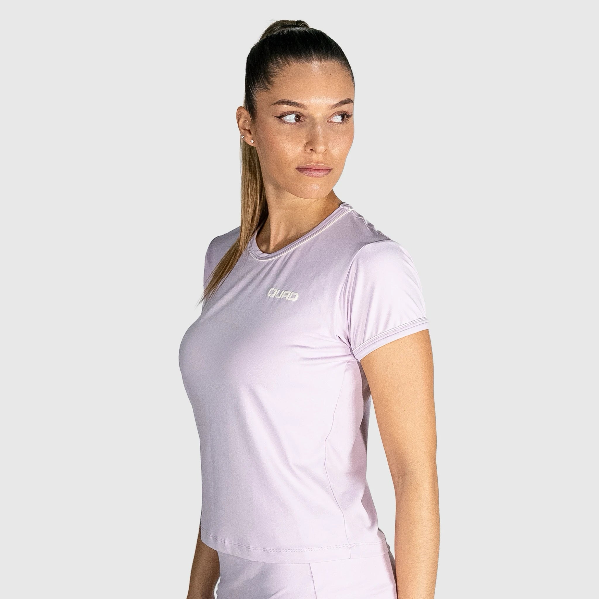 Woman wearing New Regular Padel shirt  with a visible brand logo on a white background
