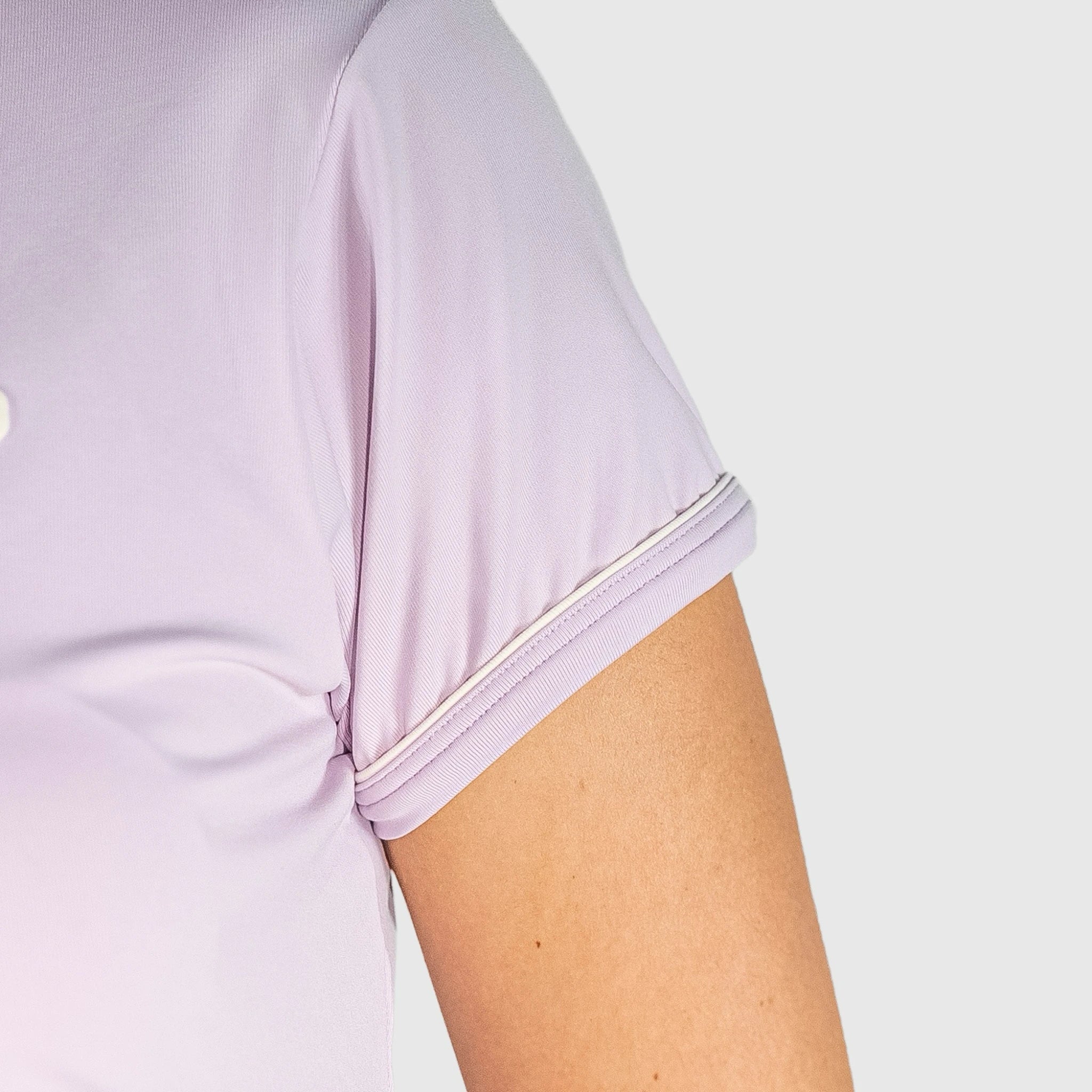 Close-up of a light New Regular Padel shirt with a white trim on a plain background